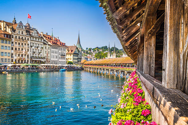 Historic town of Lucerne with Chapel Bridge, Switzerland Famous Chapel Bridge in the historic city center of Lucerne, the city's symbol and one of Switzerland's main tourist attractions and views on a sunny day in summer, Canton of Lucerne, Switzerland. footbridge photos stock pictures, royalty-free photos & images