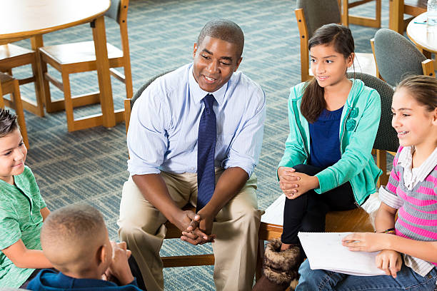 istock School counselor meeting with diverse group of students after school 503690662