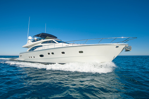 Aerial view of luxury yacht moving fast at Adriatic sea during sunny day.