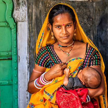 Young Indian mother breastfeeding her newborn child, Amber near Jaipur, Rajasthan, India.