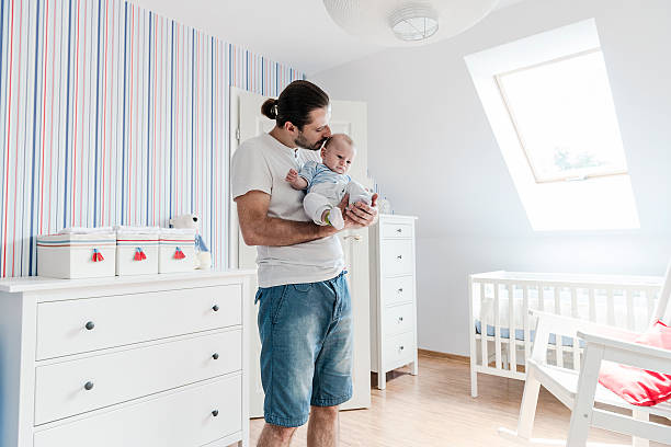 istock Father looking after his son, holding baby boy on hands 503697537