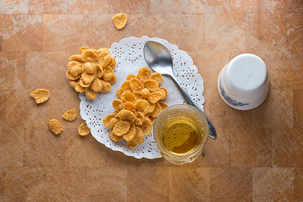 cornflakes in bowl and tea cup on table