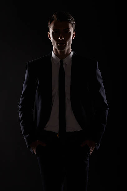 istock Business man in black suite, backlight 503698783