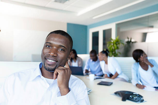 istock African businessman smiling while sitting at the boardroom table 503700121