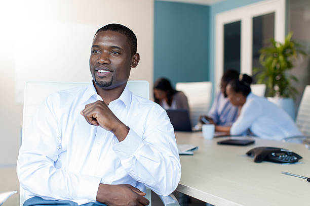 istock African businessman smiling while sitting at the boardroom table 503700123