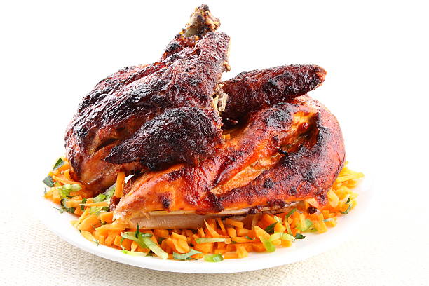 Grilled chicken meat with vegetable salad served in white plate.