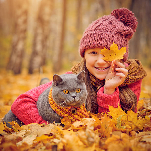 istock Child and cat in autumn 503703029