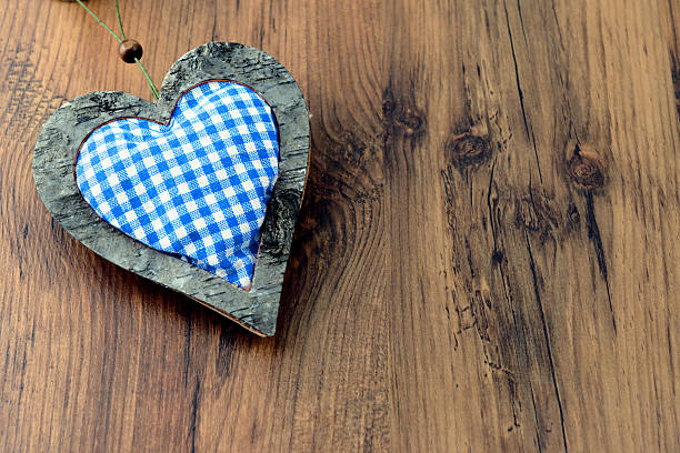 wodden Beer Fest heart with blue white pattern on wooden table with copy space.  Birch tree wood.
