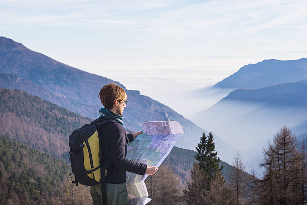 istock Woman reading trekking map on the Alps 503704004