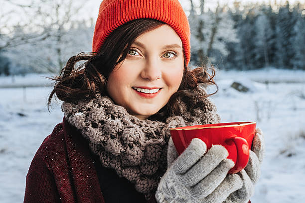 istock Winter Woman drinking hot chocolate outdoors in snow 503705310