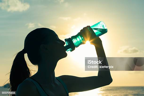 Woman Drinking Water Stock Photo - Download Image Now - Beach, Drinking, 20-29 Years