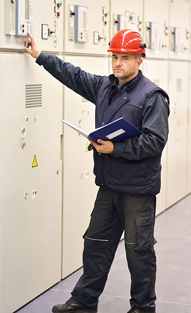 istock Technician Checks the Functionality of the Equipment in Electrical Room 503706116
