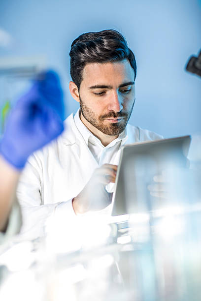 istock doctor looking   findings on a tablet in the lab 503706196