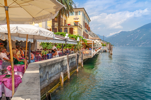 Lake Garda, Italy - July 1st, 2006;  Tourists enjoying a sunny afternoon in the lakeside restaurants of Limone, Lake Garda, Italy