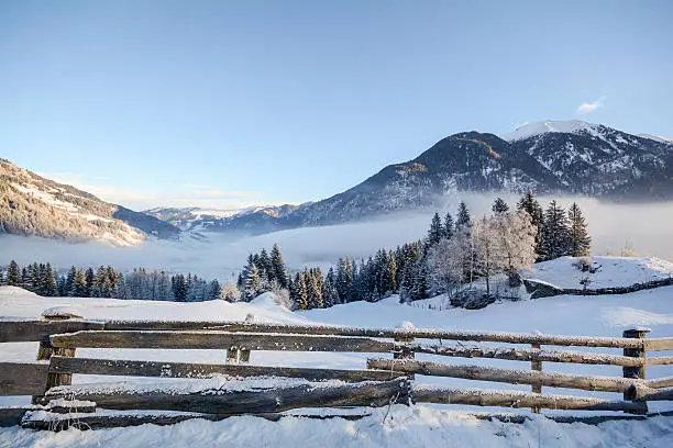 View to a winter landscape with wooden fence, Gasteinertal valley near Bad Gastein, Pongau Alps - Salzburg Austria Europe