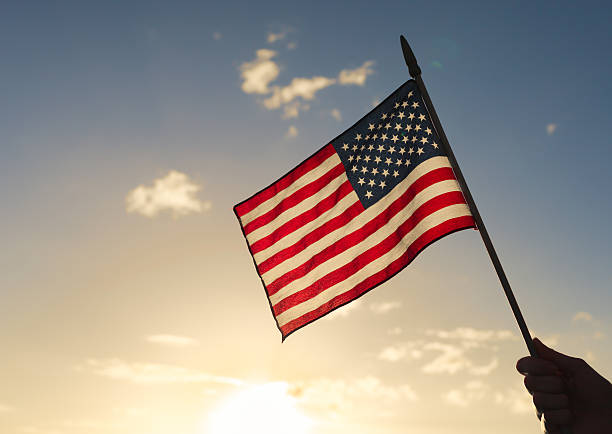American flag Person holding american flag. patriotic man stock pictures, royalty-free photos & images