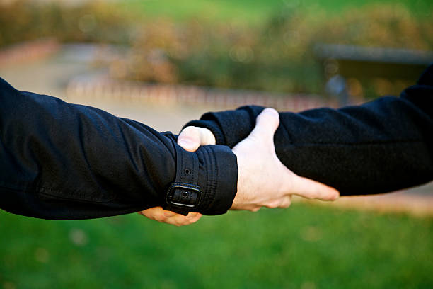 istock Helping hand support holding on each other at the wrists 503707630