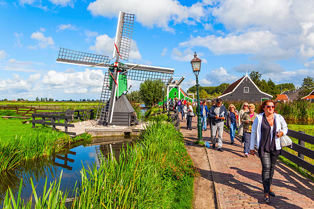windmills at Zaanse Schans, Netherlands Zaanse Schans, Netherlands - September 02, 2015: unidentified people at the museum village. A collection of historic windmills and houses from the region were moved to the area starting 1961 zaanse schans stock pictures, royalty-free photos & images