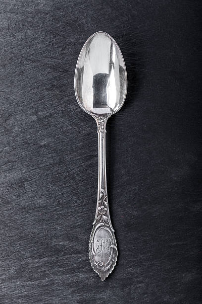 Silver spoon Silver spoon vintage, early 1930s with elaborate floral design baby spoon stock pictures, royalty-free photos & images
