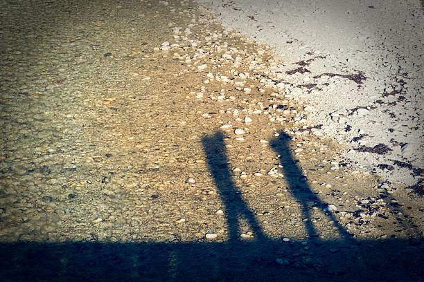 Couple walking on a bridge crossing a river. 
