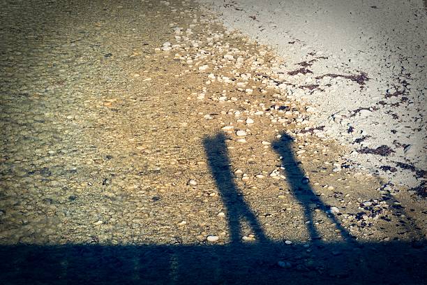 Shadow silhouette of a couple walking. stock photo