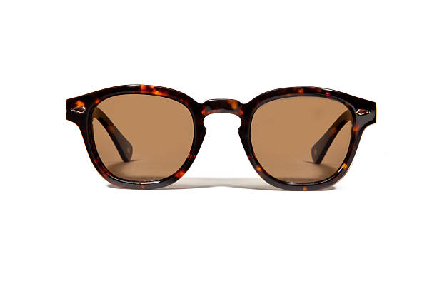 Pair of plastic tortoise shell tinted sunglasses A pair of tortoise shell plastic sunglasses photographed straight on isolated against a white background.  Brown tinted lenses tortoiseshell cat stock pictures, royalty-free photos & images