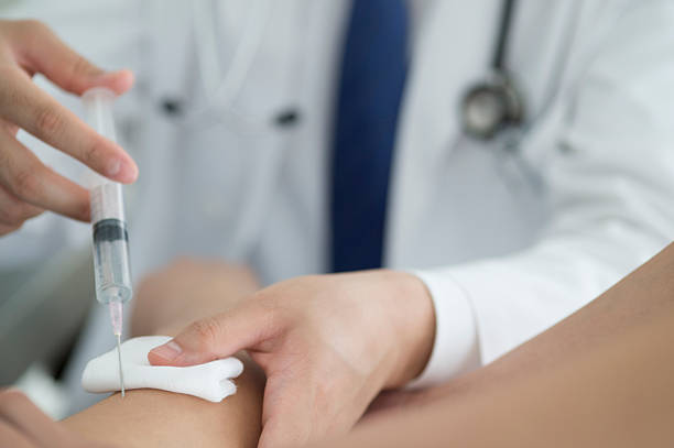 istock Patients get injected vaccine with a syringe 503713614