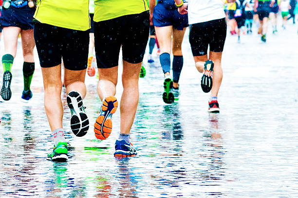 istock people running in a marathon on a wetted surface 503713654