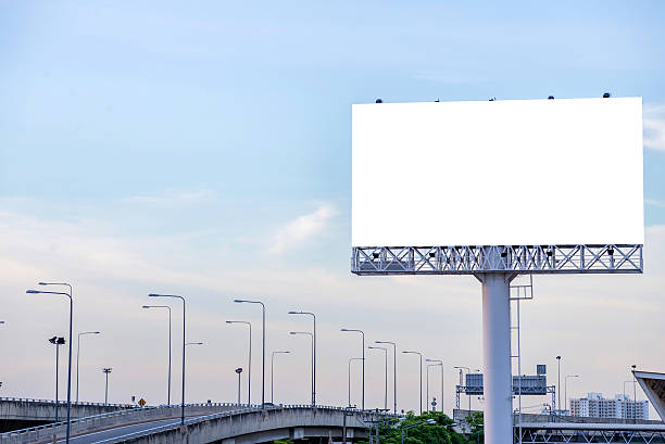 istock large blank billboard on road with city view background 503718136