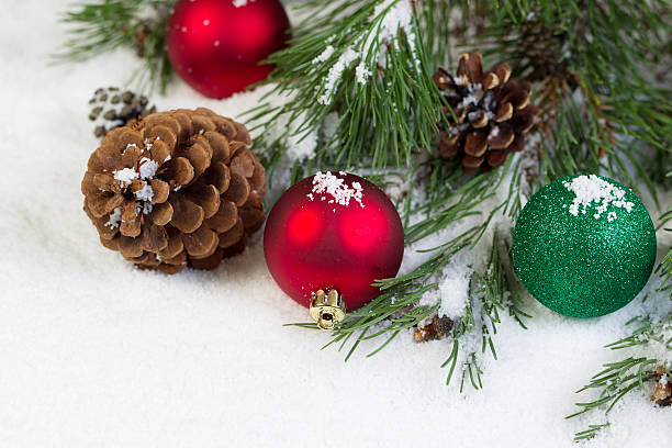 istock Christmas Ornaments on Snow with Pine Tree Branch 503726927