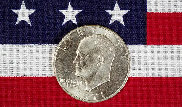 Closeup view of United States Silver Dollar Coins, President Eisenhower, placed on American Flag