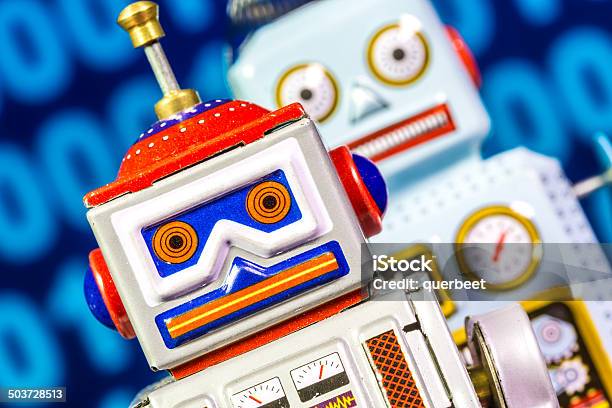 Two Retro Tin Robots With Binary Code Stock Photo - Download Image Now - 1960-1969, Abstract, Binary Code