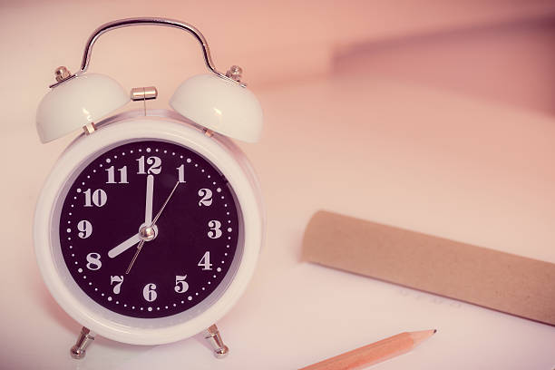 istock alarm clock on the bed in bedroom, retro style 503728564