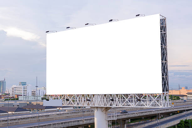 istock large blank billboard on road with city view background 503728730