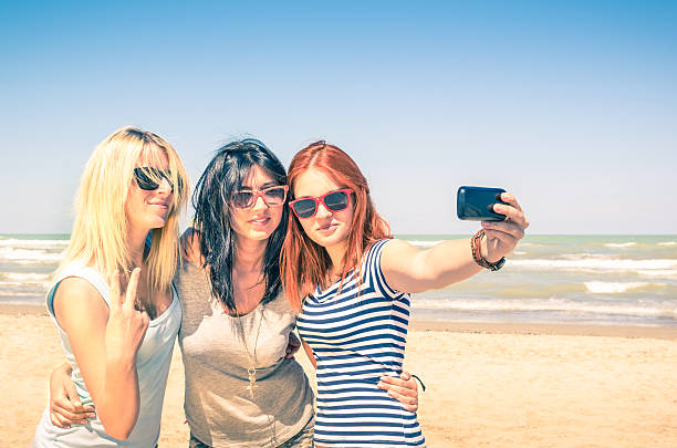 istock Group of girlfriends taking a selfie at the beach 503728813