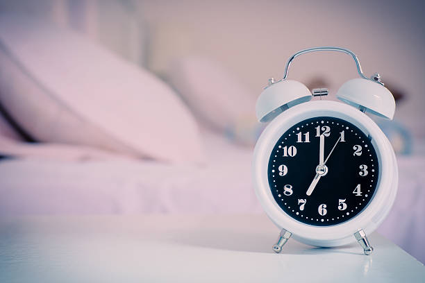 istock alarm clock on the bed in bedroom. 503729894