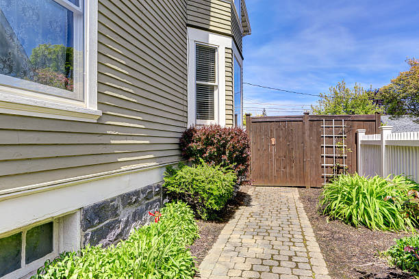 istock House backyard view. Walkway with bushes alongside 503731779