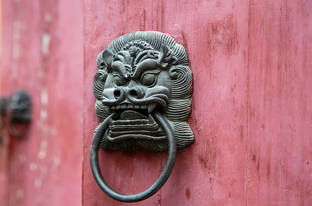 istock ancient iron lion knocker on wooden door 503731848
