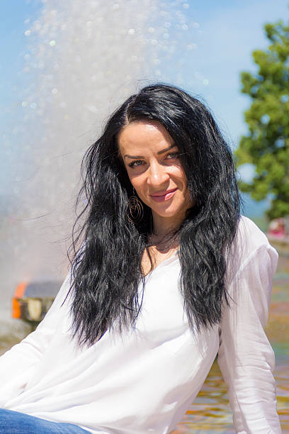istock Brunette woman on fountain background 503733040