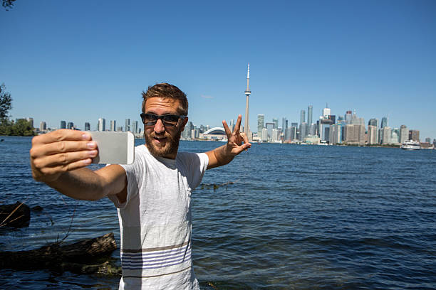 istock Young cheerful man in Toronto-Canada taking a selfie portrait 503736066