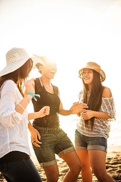istock friends dancing on the beach for a party 503736760