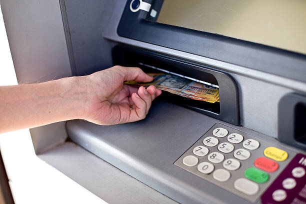 istock Person withdrawing cash from ATM 503738306