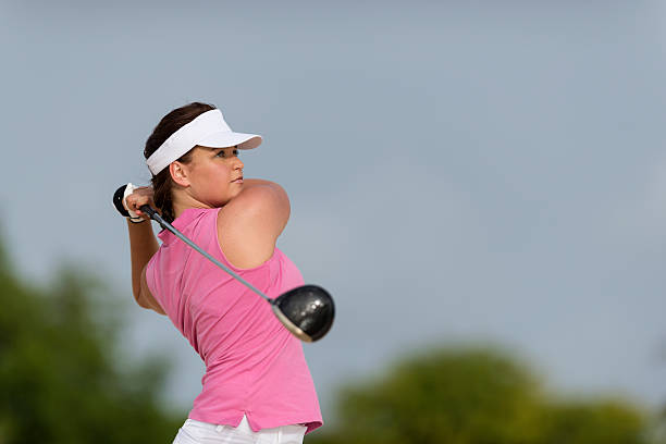 istock Lady golfer playing a shot sky background 503739296