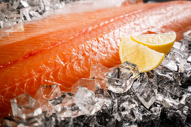 istock Salmon fish on ice on a black table 503742110