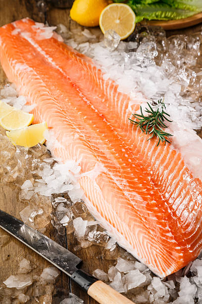 istock Salmon fish on ice on a wood table 503742764