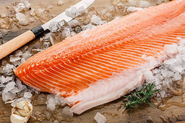 istock Salmon fish on ice on a wood table 503743166