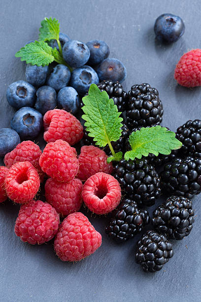 istock Assorted fresh berries on a black background, close-up 503743934
