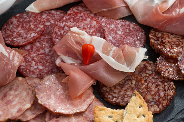 istock Assorted meat snacks, sausages on a blackboard, top view 503750938