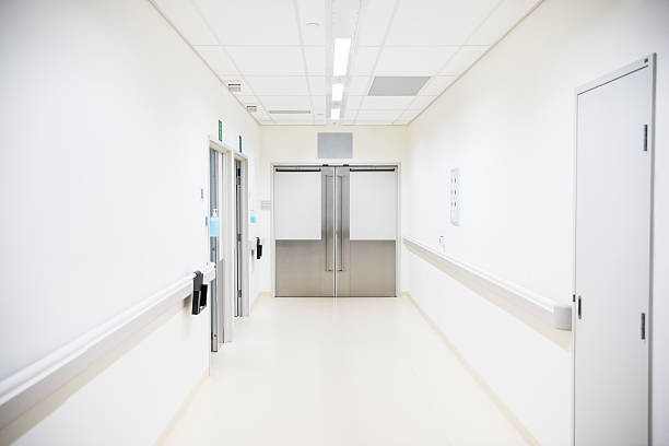 istock Empty hospital corridor with closed doors at the end 503750994