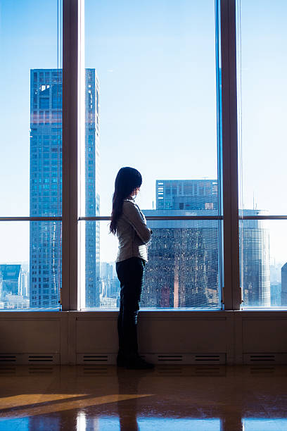 istock Young woman looking through the window 503752444